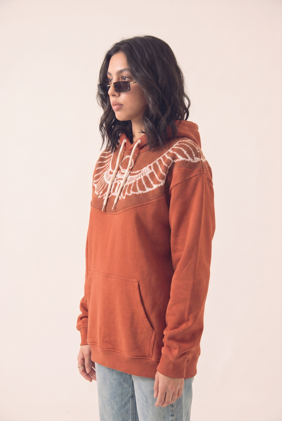 Berry red hoodie with Horus inspired pattern, side view