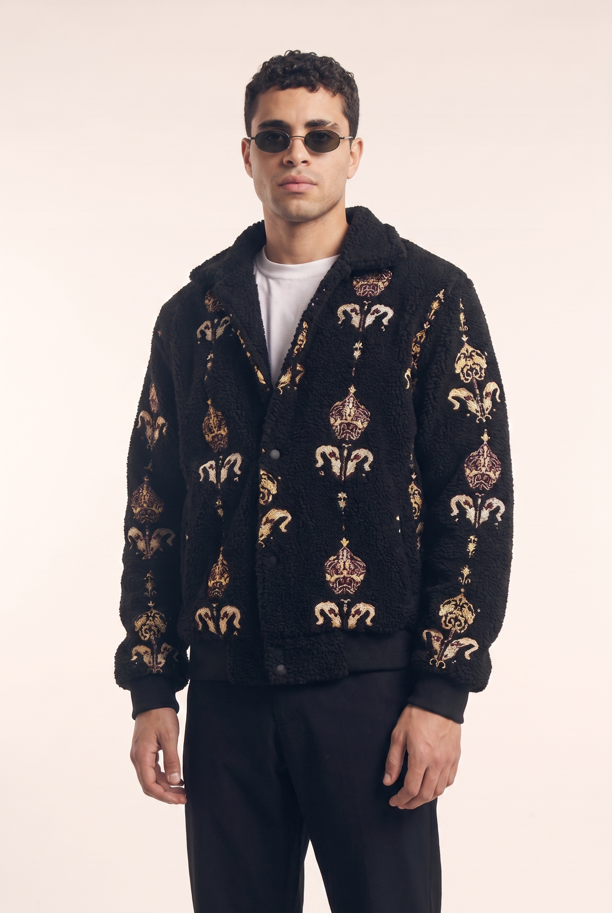 Black fleece jacket with Arabia Royalty Islamic embroidered pattern, front view.