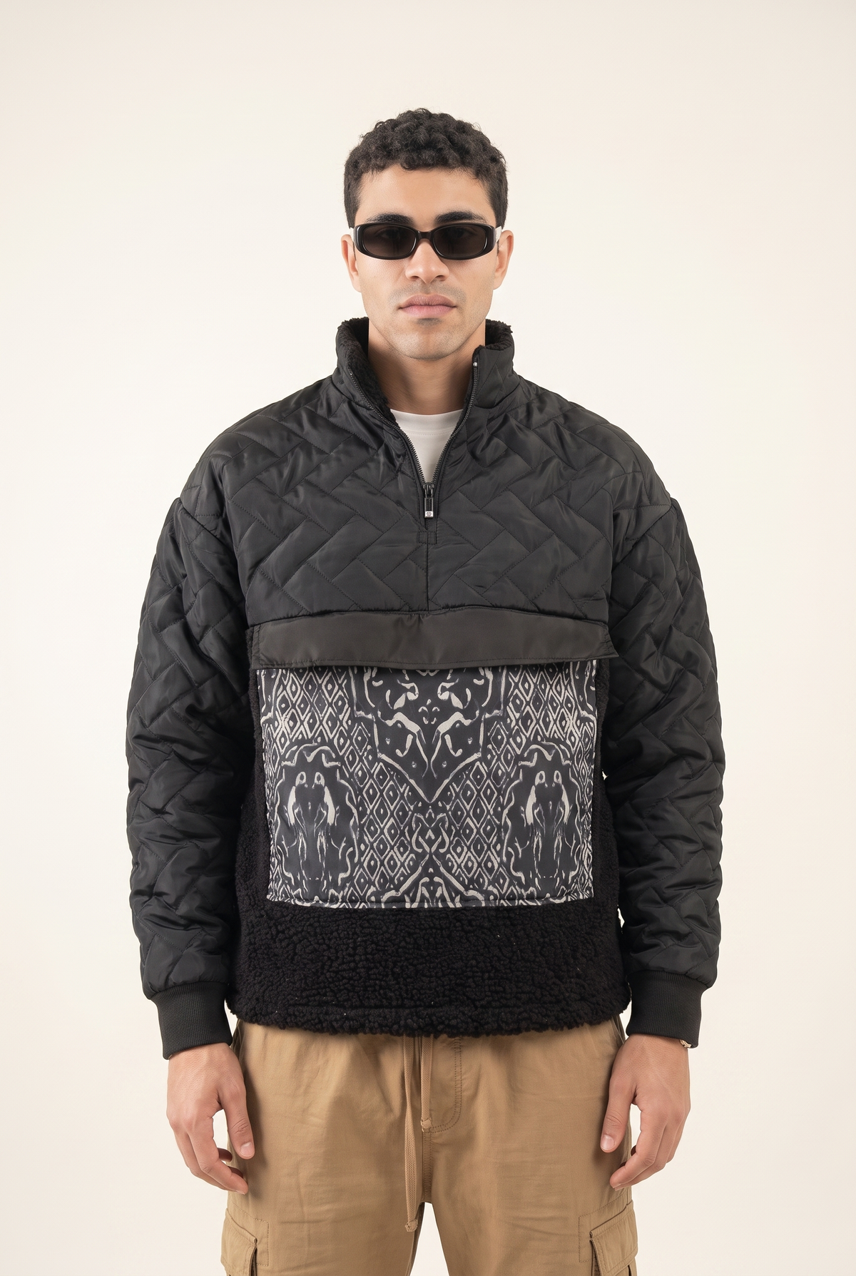 Black sweatshirt with intertwined Islamic art pattern on the front pocket, front view.