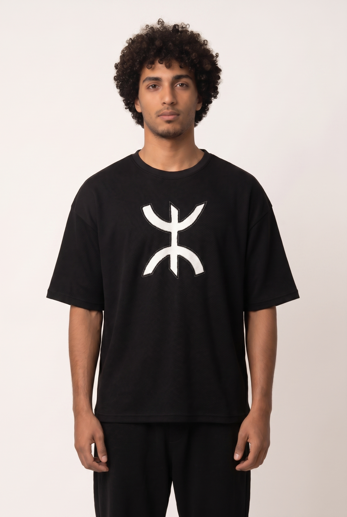Black Free Spirit Tshirt with stitched Yaz symbol emblem on the chest, front view