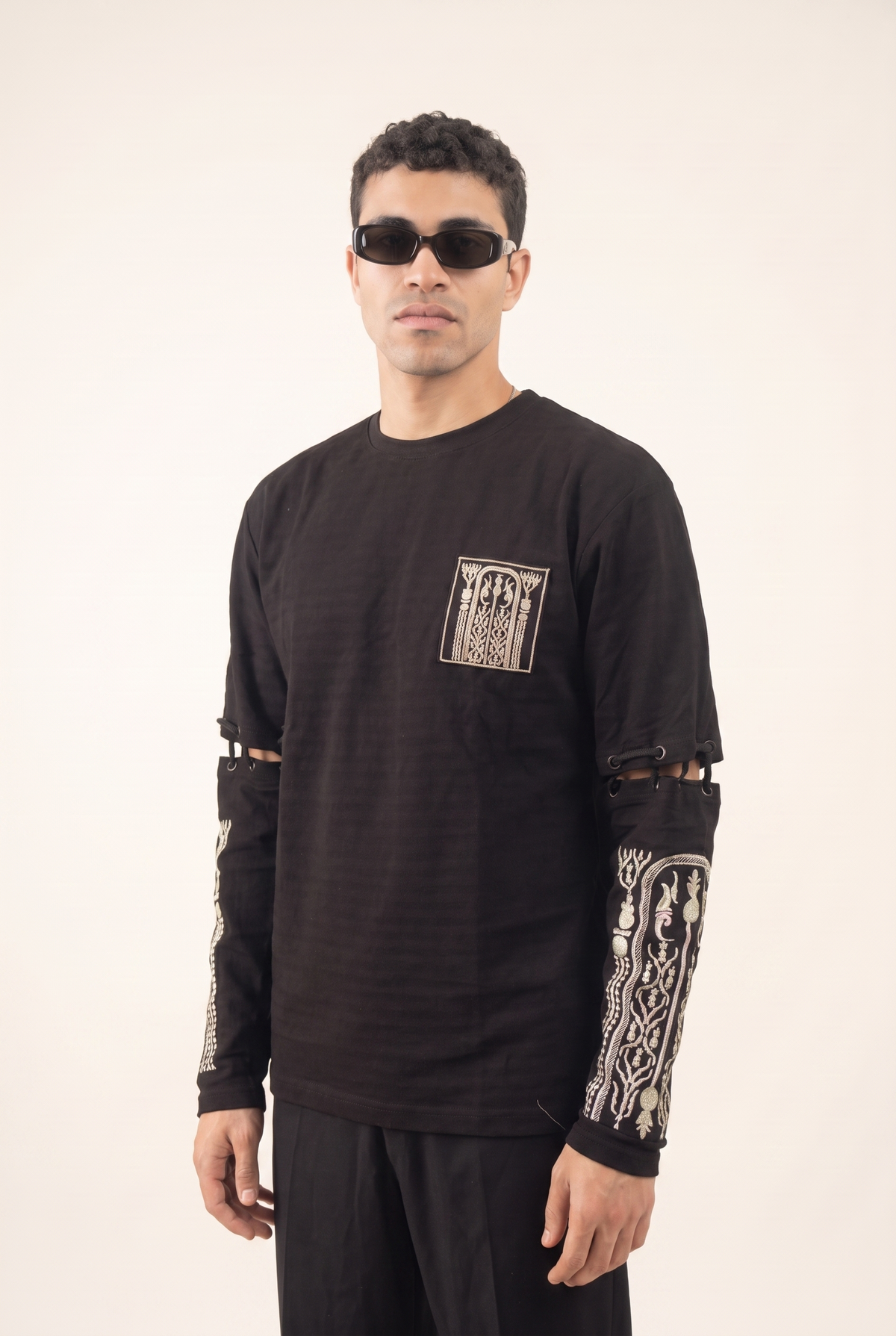 Black cotton shirt with gold Islamic-inspired embroidery on the lower sleeves, front view.