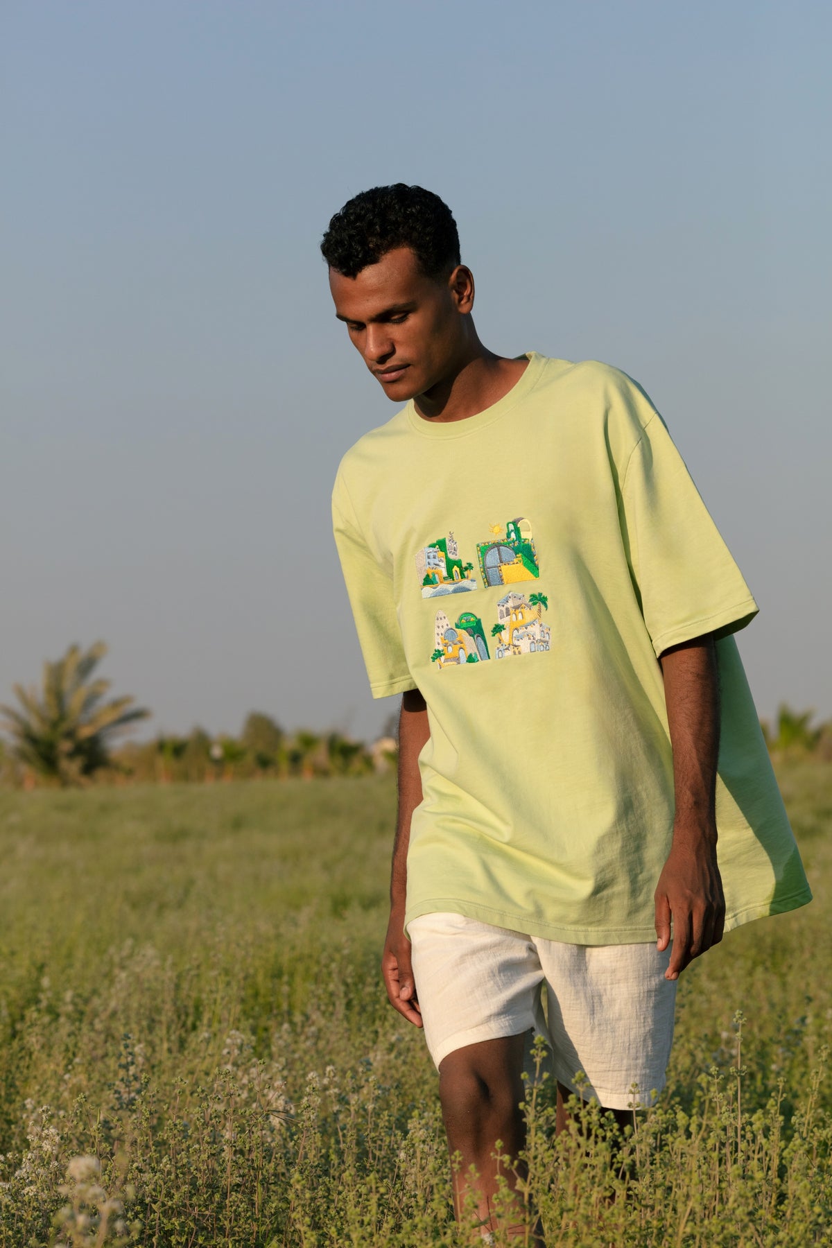 Green Houses graphic tee worn, styled view.