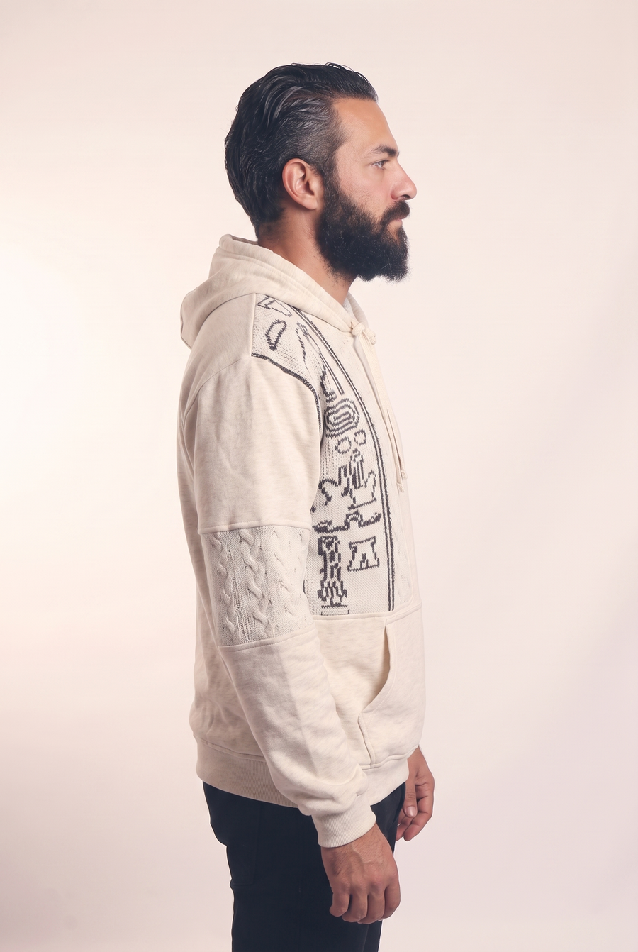 Beige knit hoodie with hieroglyph pattern, side flat lay