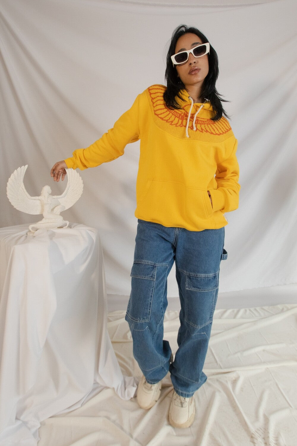 Yellow Horus hoodie, close up of the fabric and pattern