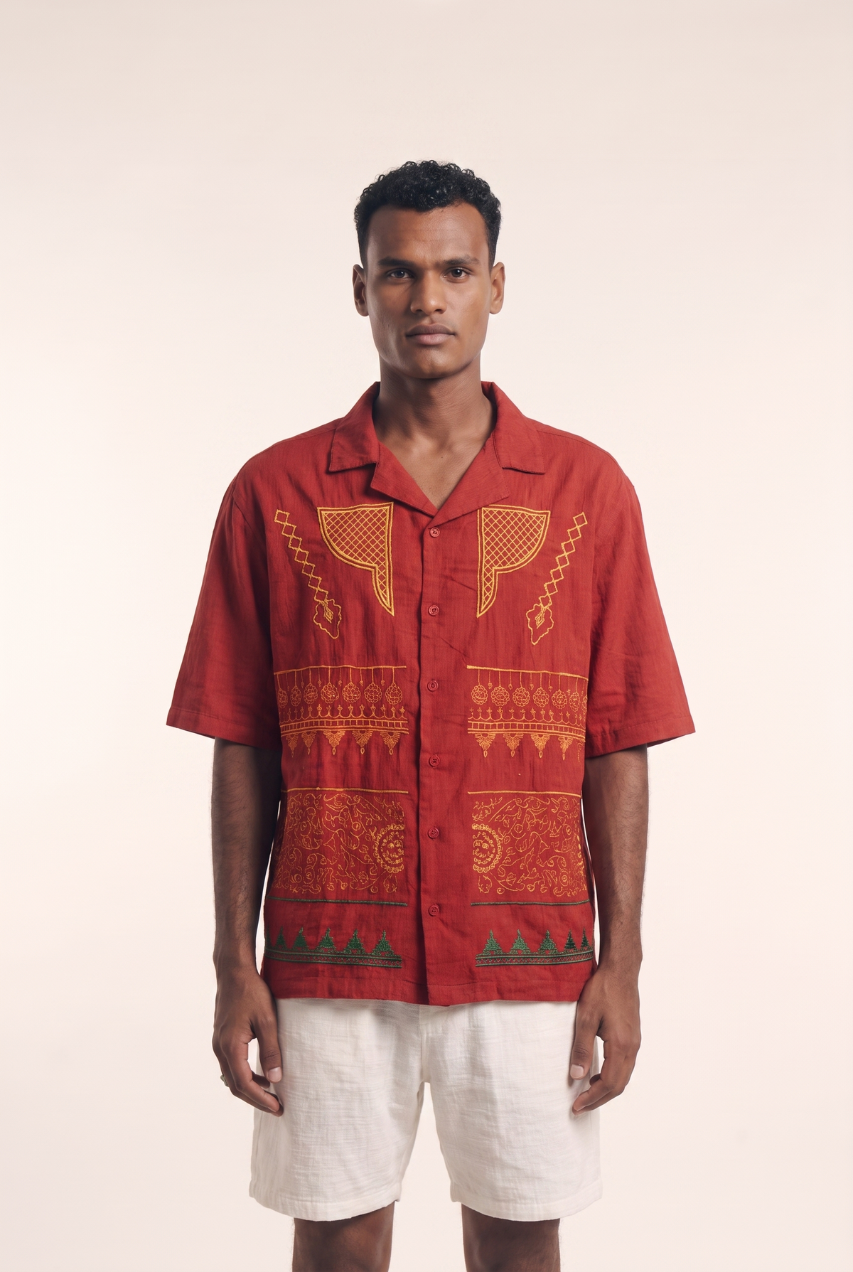 Maroon Nubian button-up shirt with heritage embroidered motifs, front view.