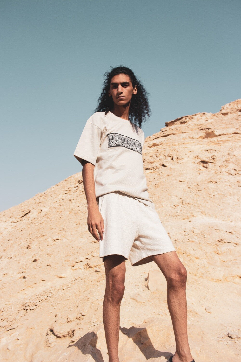 Beige cotton shorts, front view on model