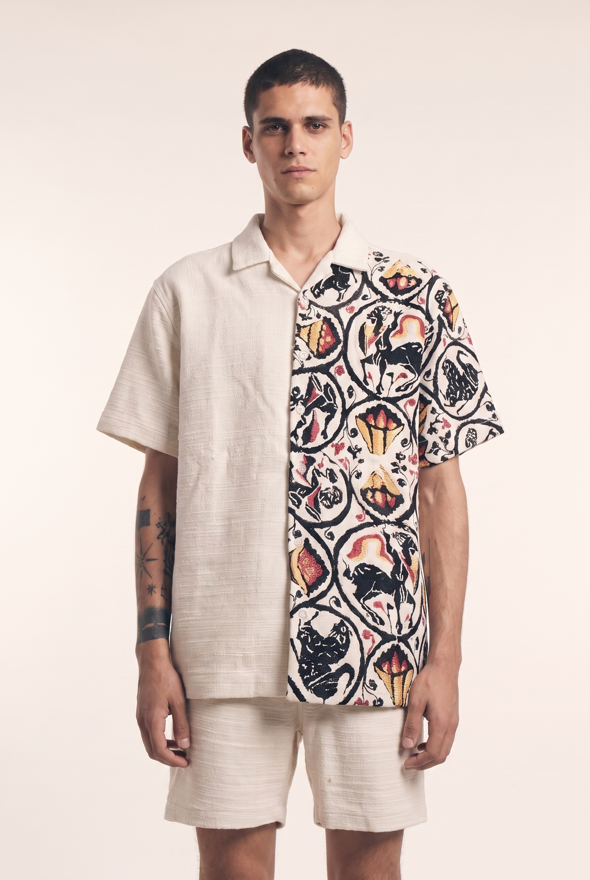 Beige button-up shirt with embroidered Centaur motif, front flat lay