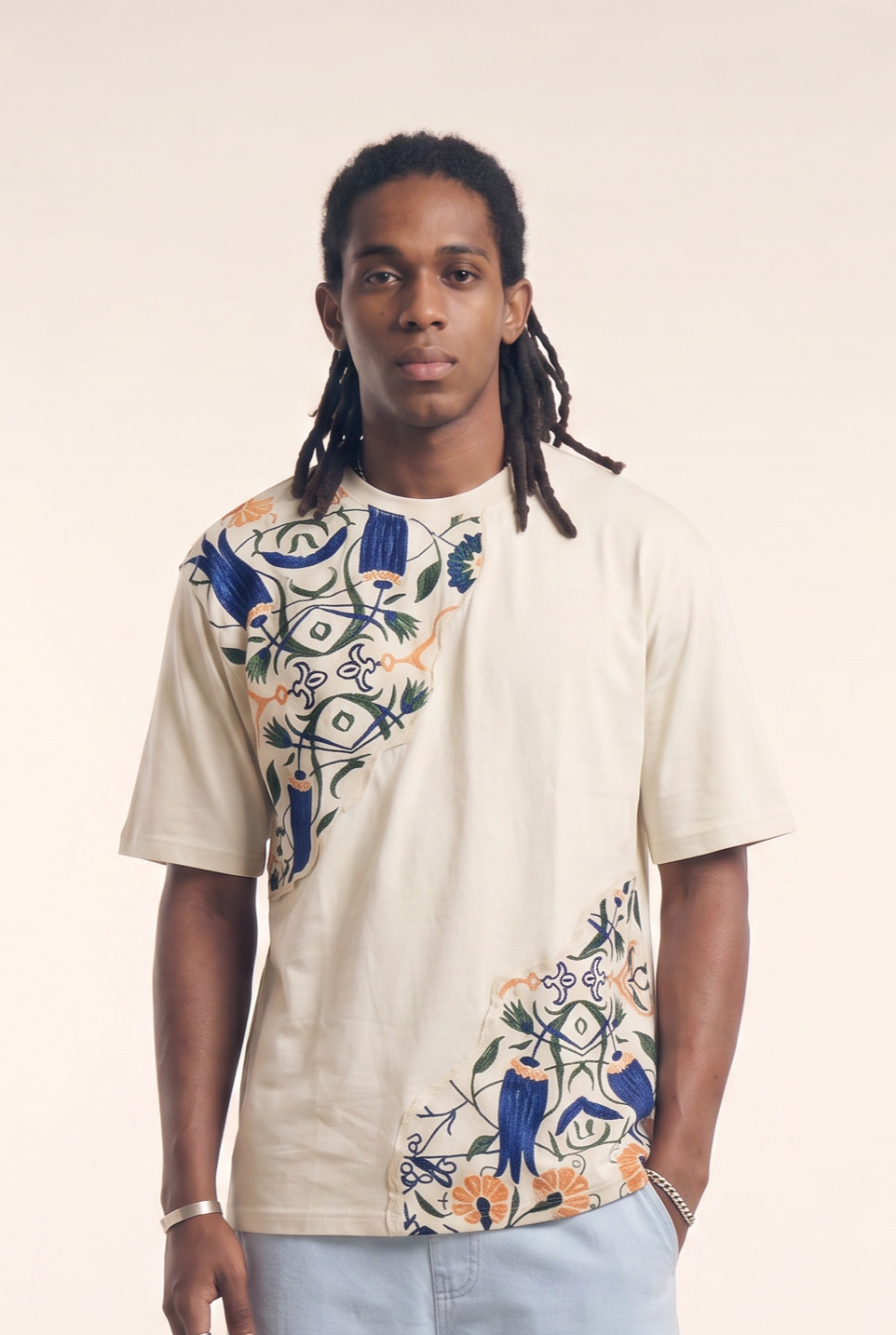 Beige tee with embroidered Islamic floral motif, front flat lay