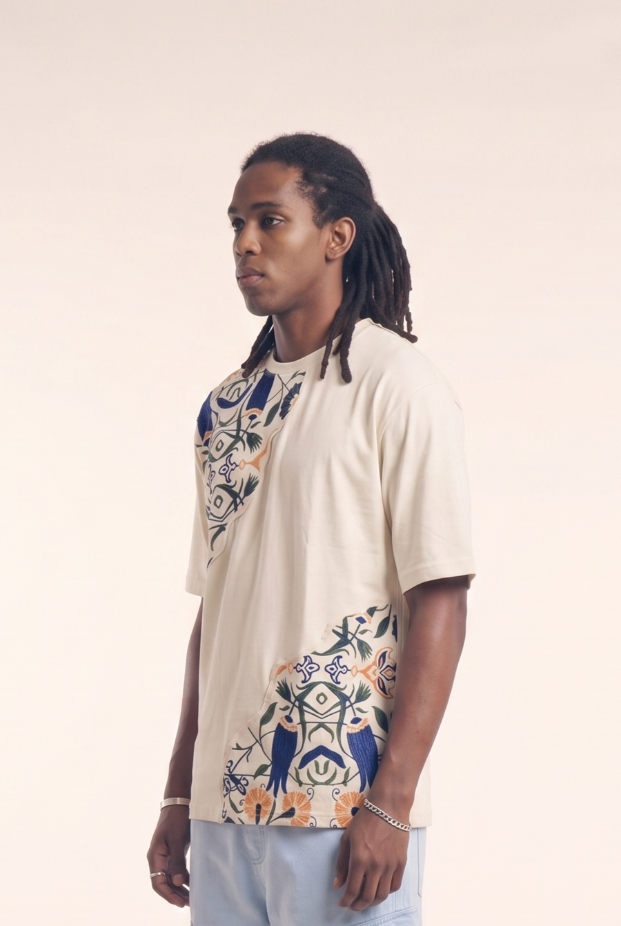Beige tee with embroidered Islamic floral motif, side flat lay