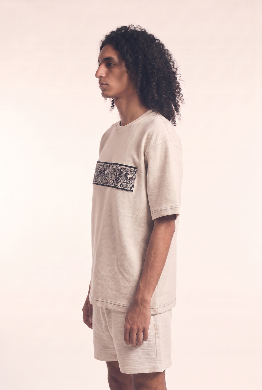 Beige tee with embroidered Lions motif, side flat lay