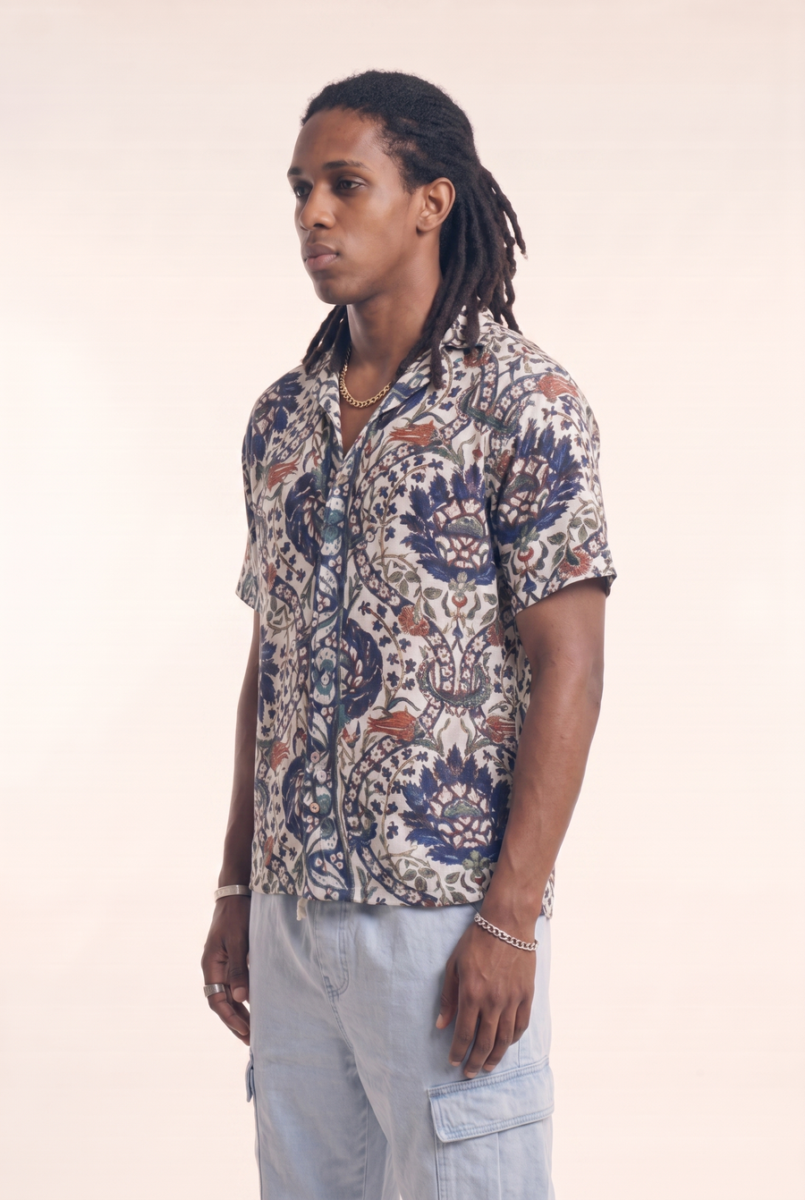 Beige button-up shirt with garden trees pattern, side flat lay
