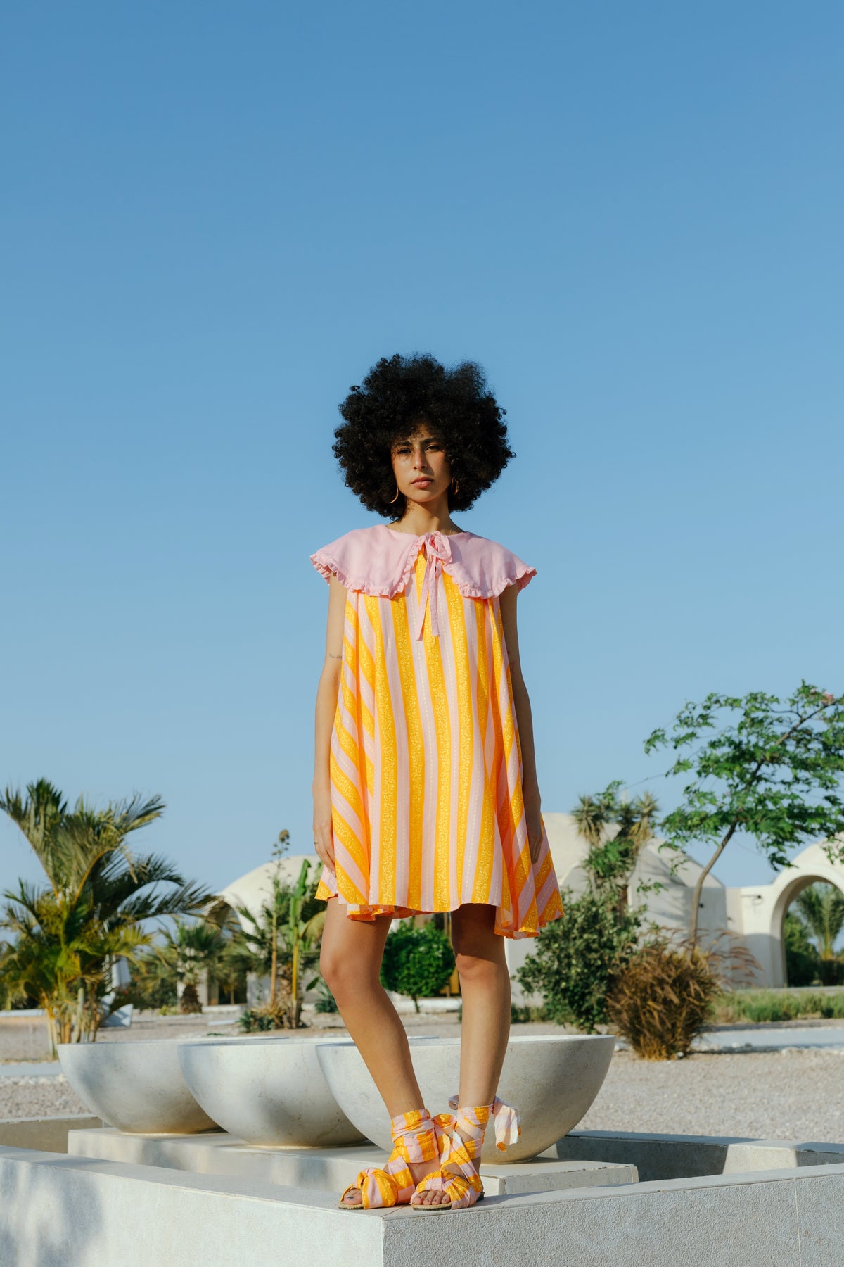 Orange Dune midi dress worn, styled view.