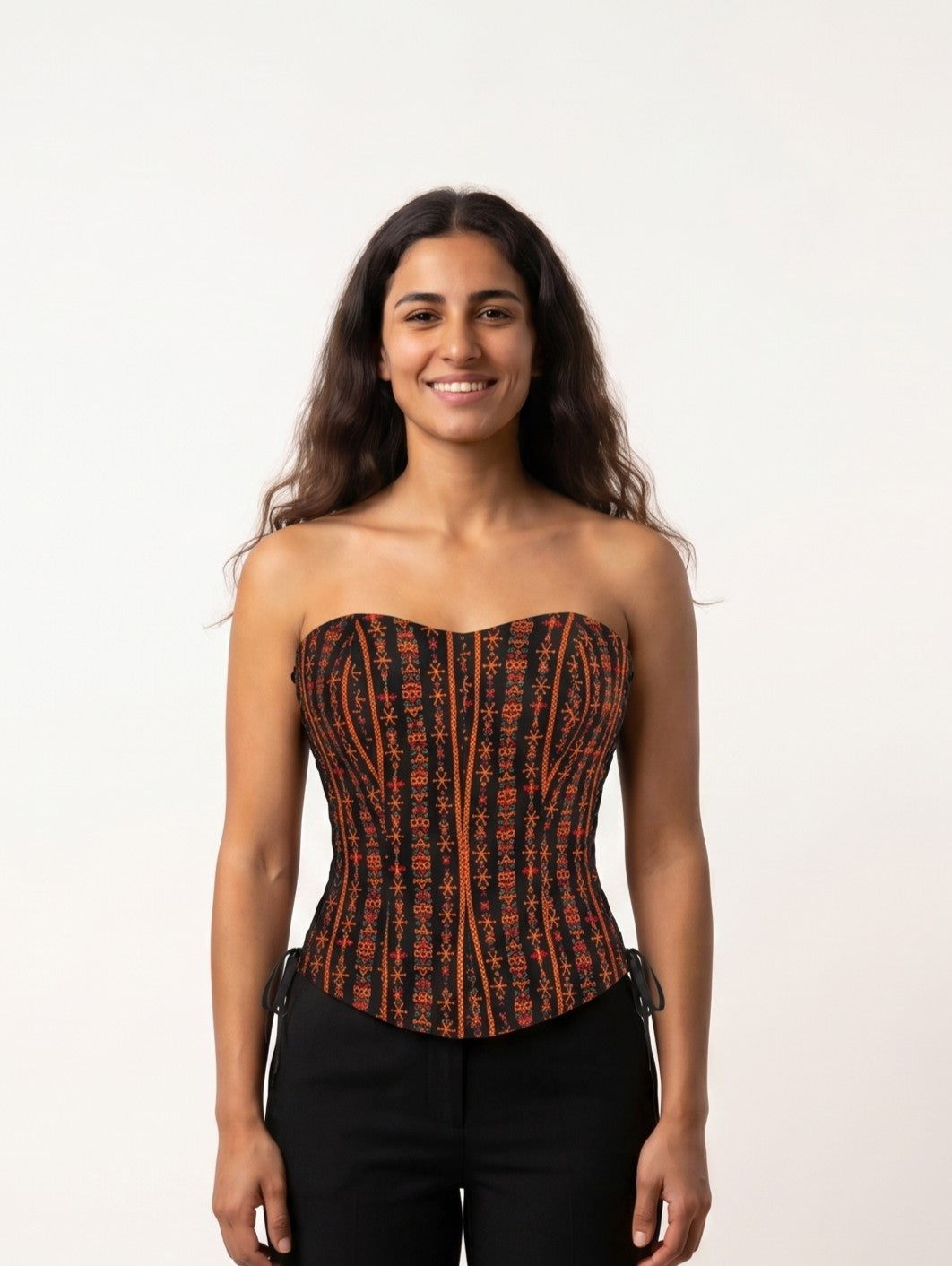 Siwi Stitches Corset in black Egyptian cotton with vertical orange Siwan geometric embroidery, front view