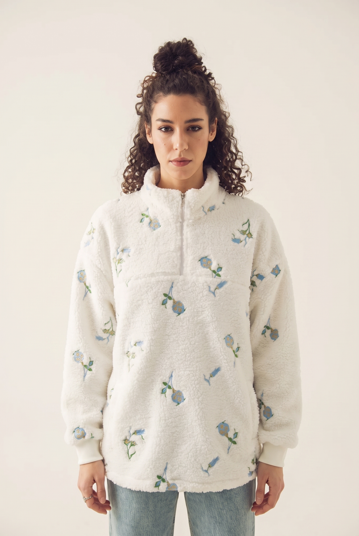 White sweatshirt with blue blossom embroidery, front view