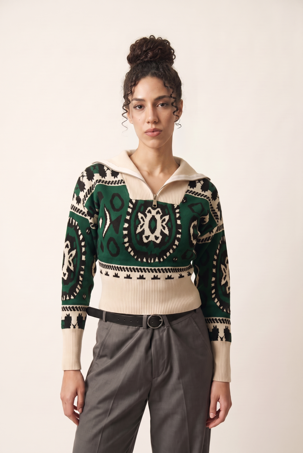 Green and beige Winter Sash pullover with Coptic-inspired pattern, front view.