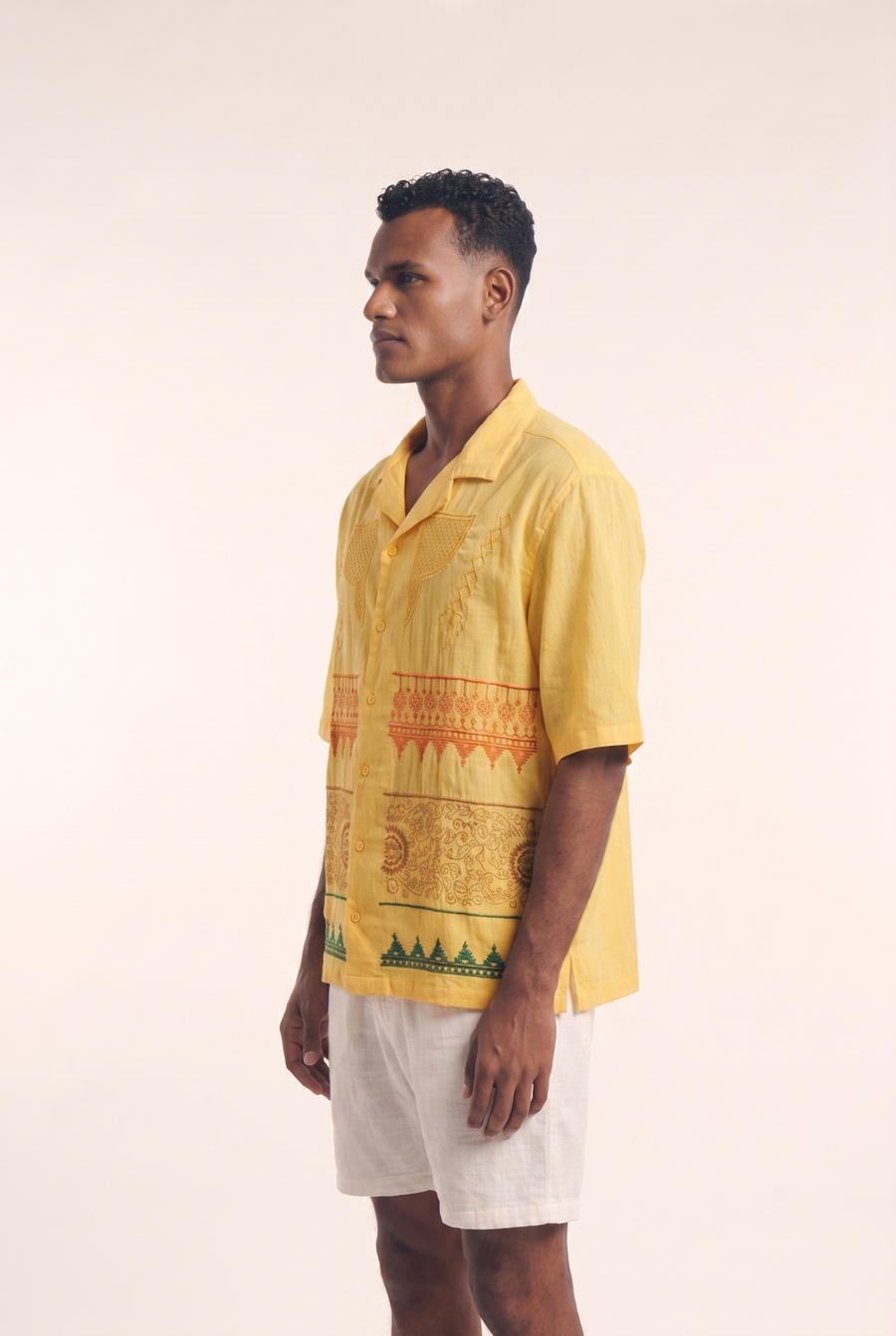 Yellow Nubian button-up shirt, side view showing the tailored silhouette.